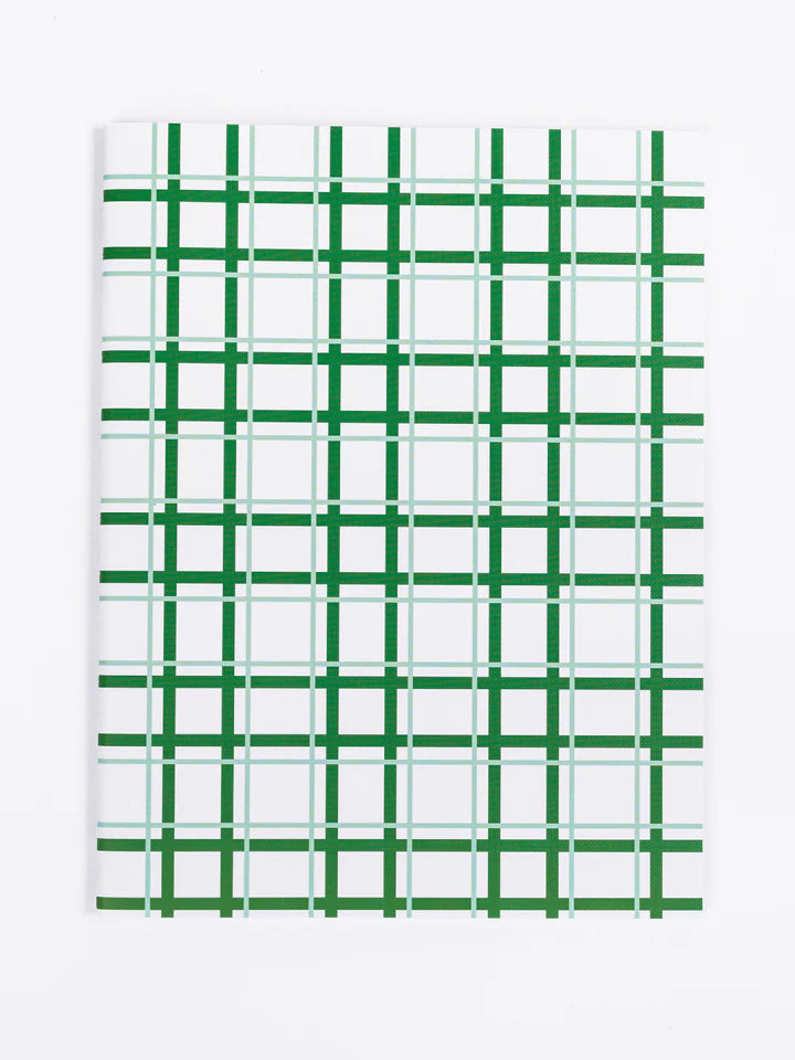 green grid notebook on a white background.