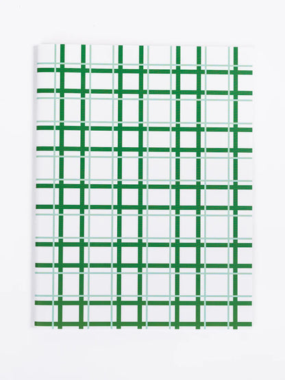 green grid notebook on a white background.