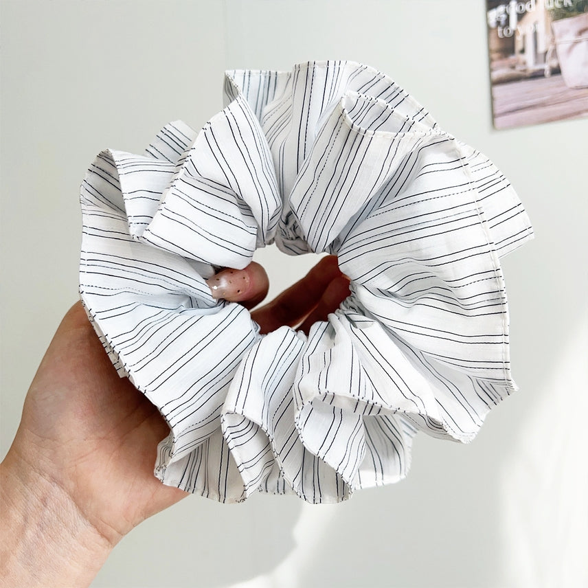 white pinstripe scrunchie being held