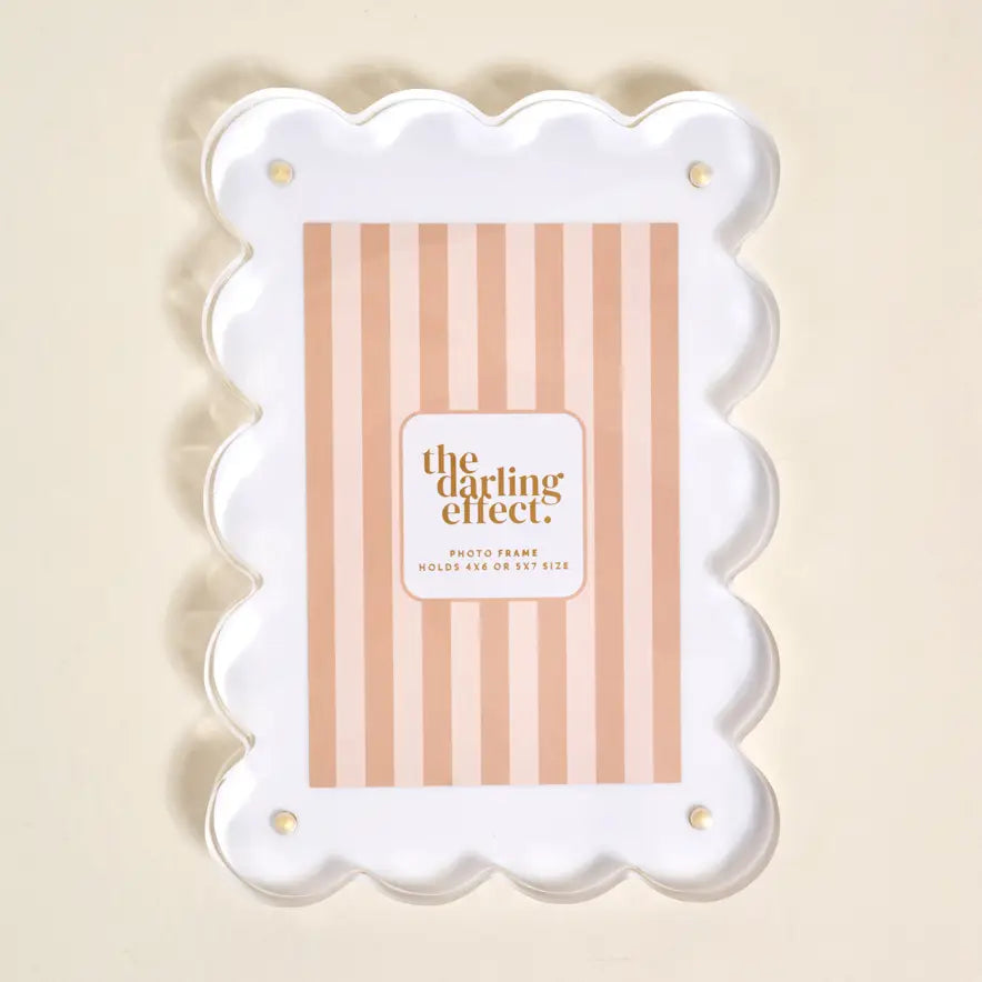 Decorative photo frame with scalloped edge and beige striped insert card on a beige background