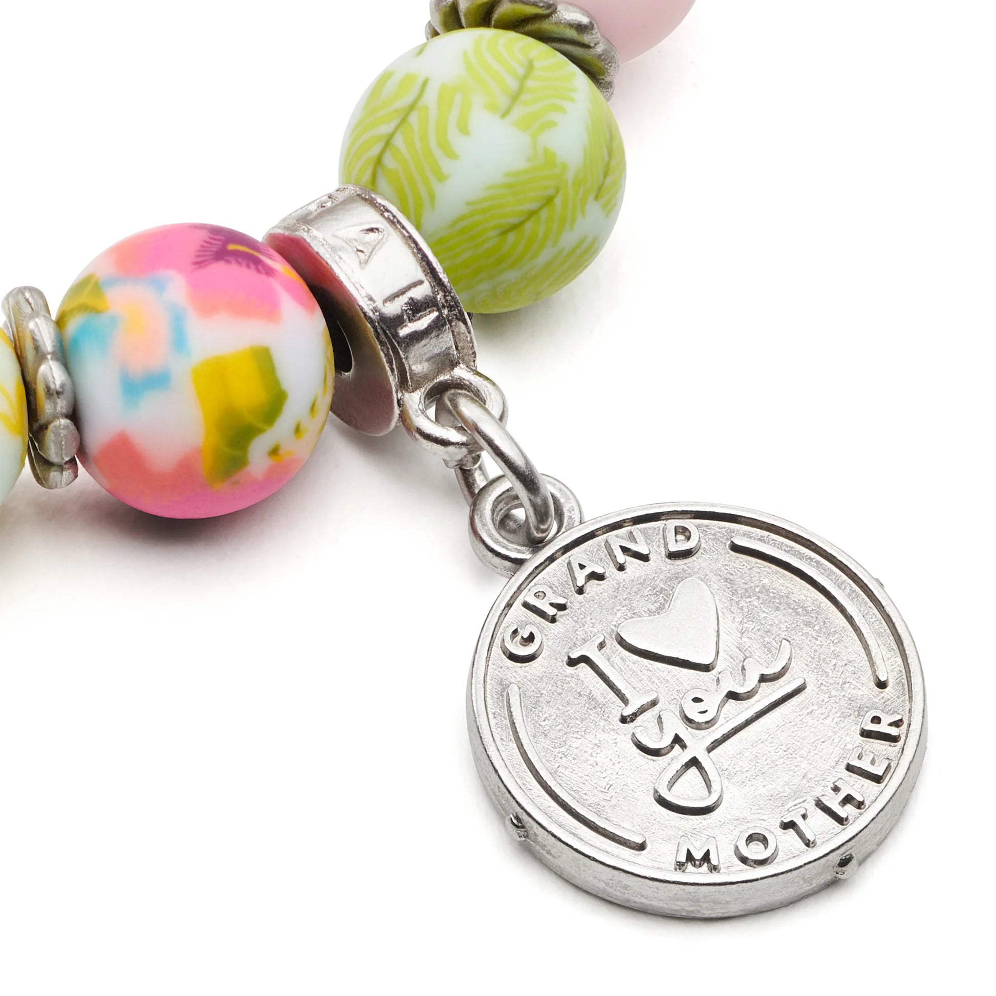 close-up of charm stamped with "grandmother i love you".