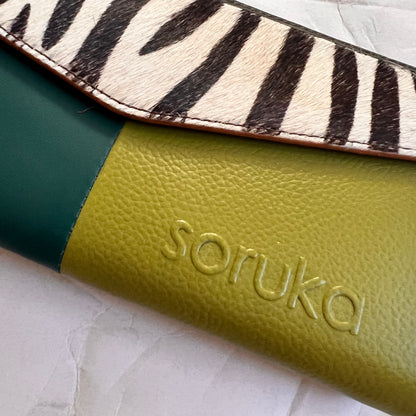 close-up of green judith wallet with animal print flap.