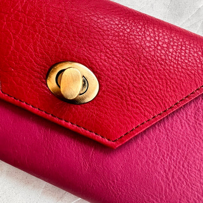 close-up of berry secret clutch wallet.