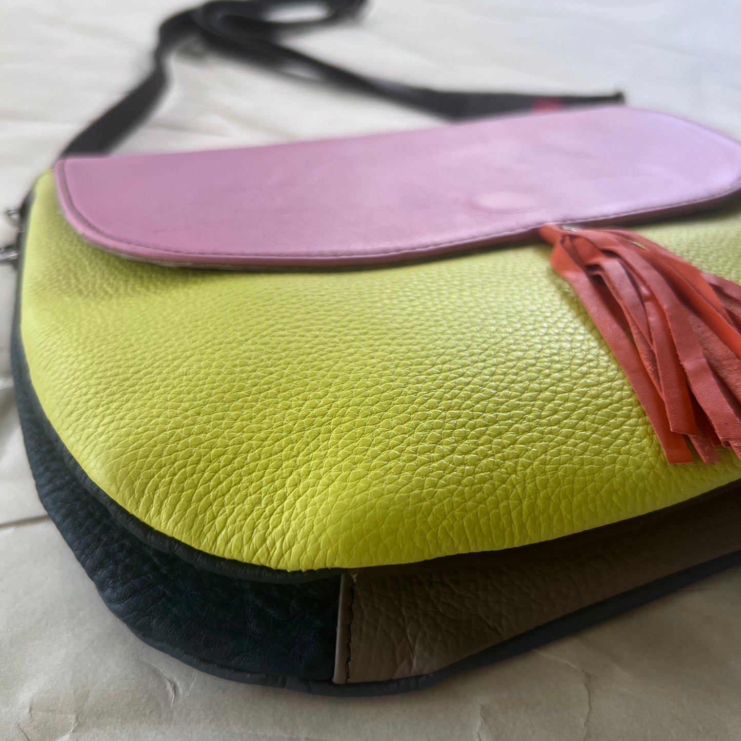 bottom view of orange tassel Lola Reversible Crossbody