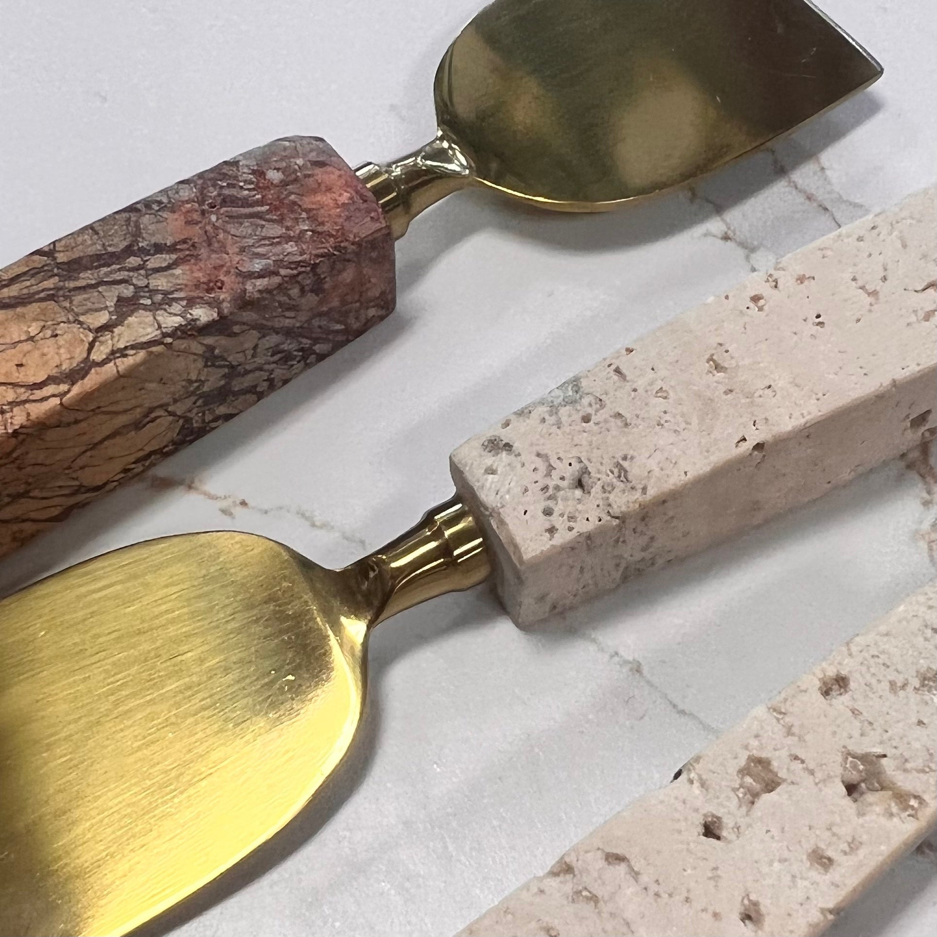 close-up of travertine cheese utensils.