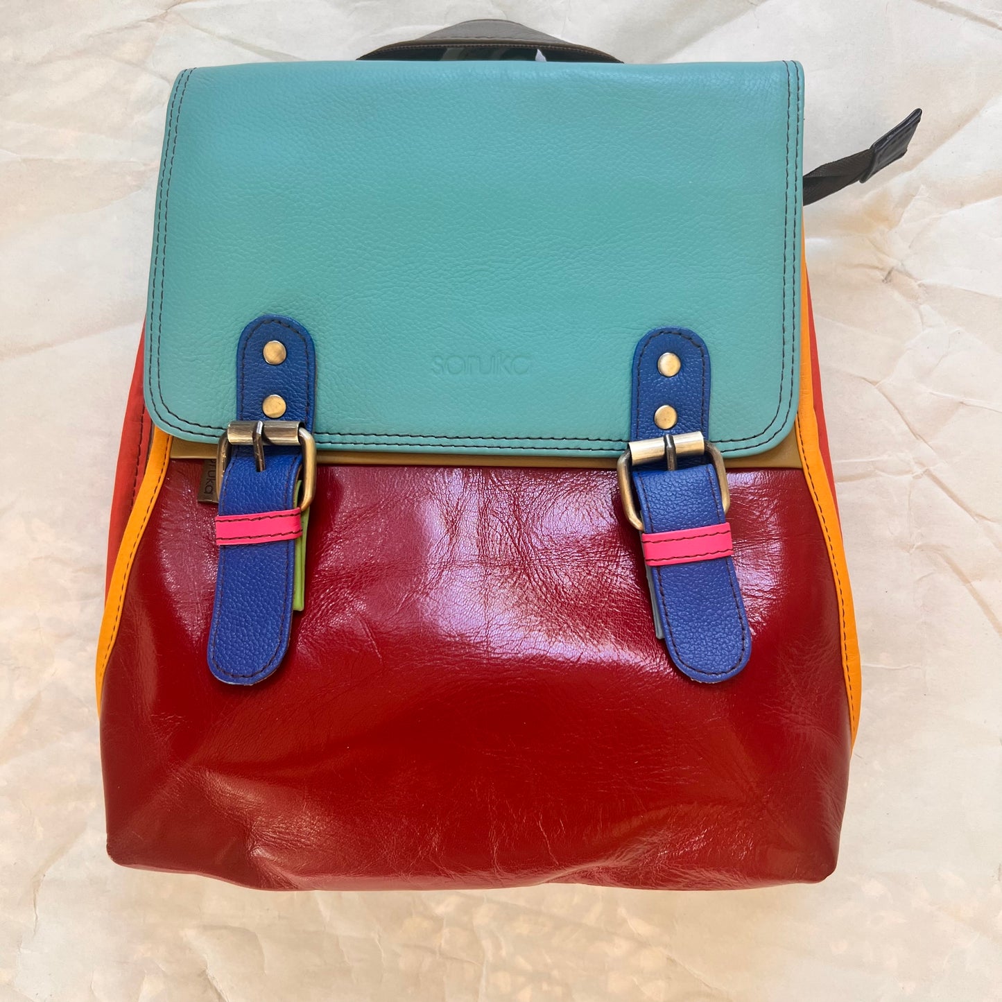 turquoise and red freya backpack.