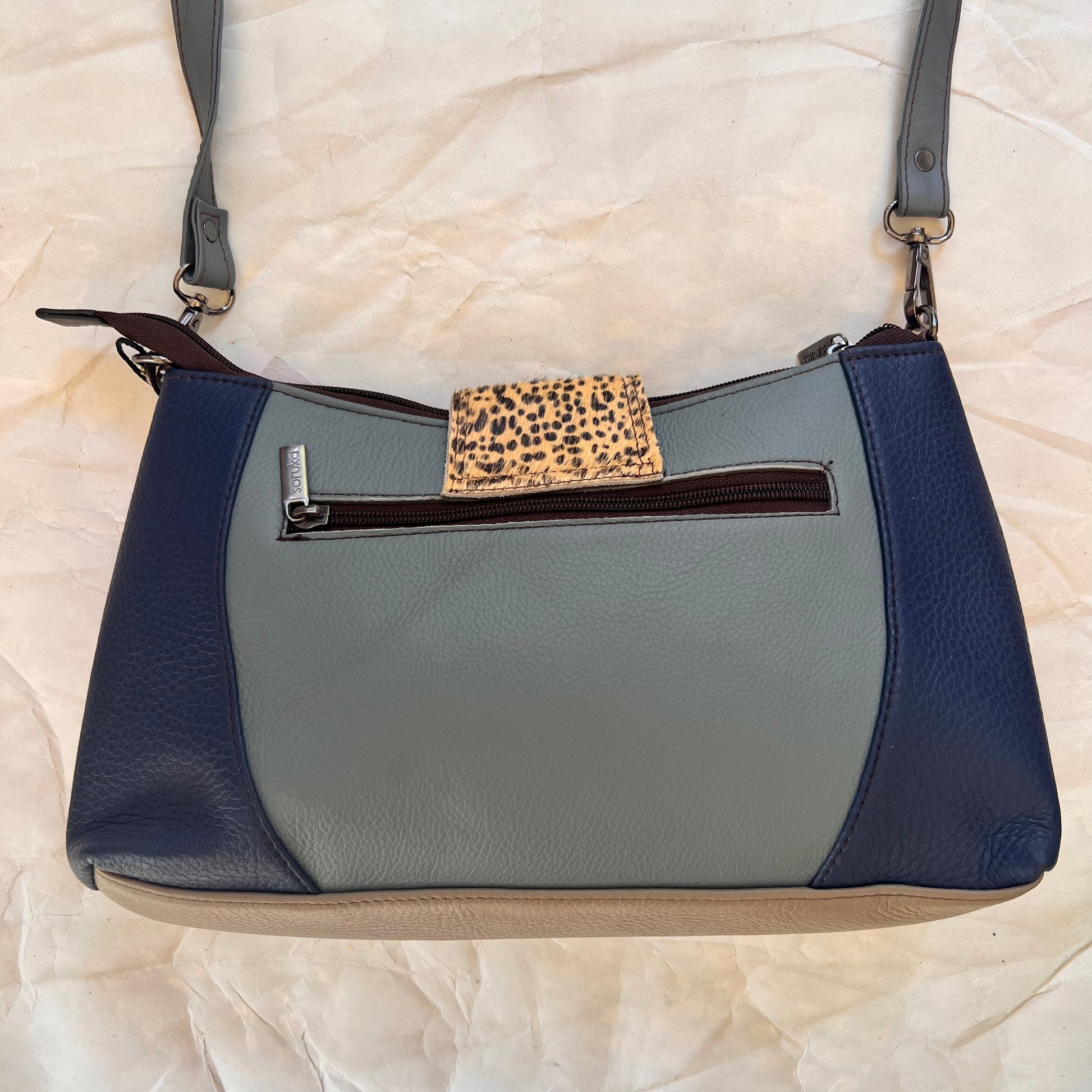 back of Amanda bag with color blocks of light and dark blues.