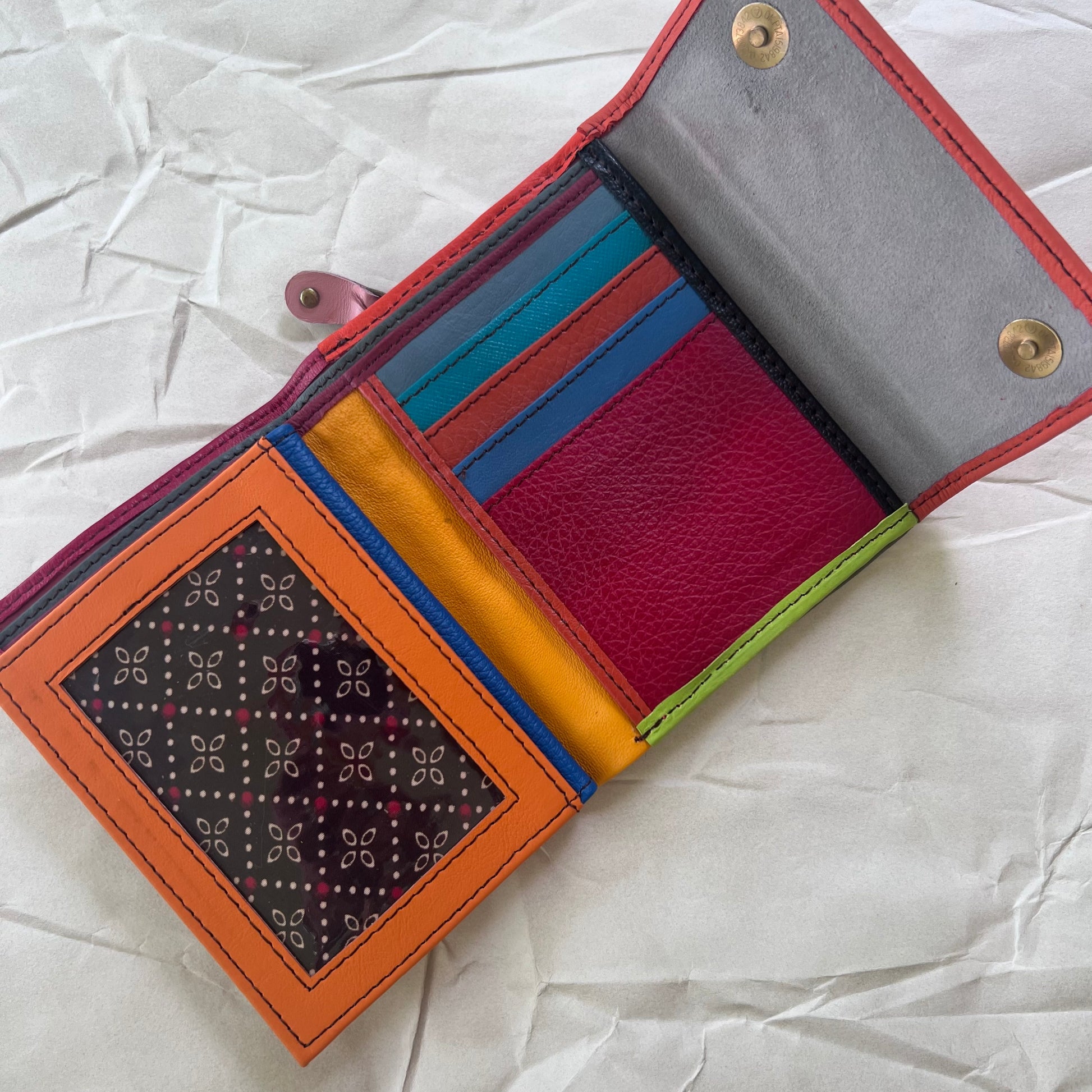 cranberry rings wallet laying open showing colorful card slots