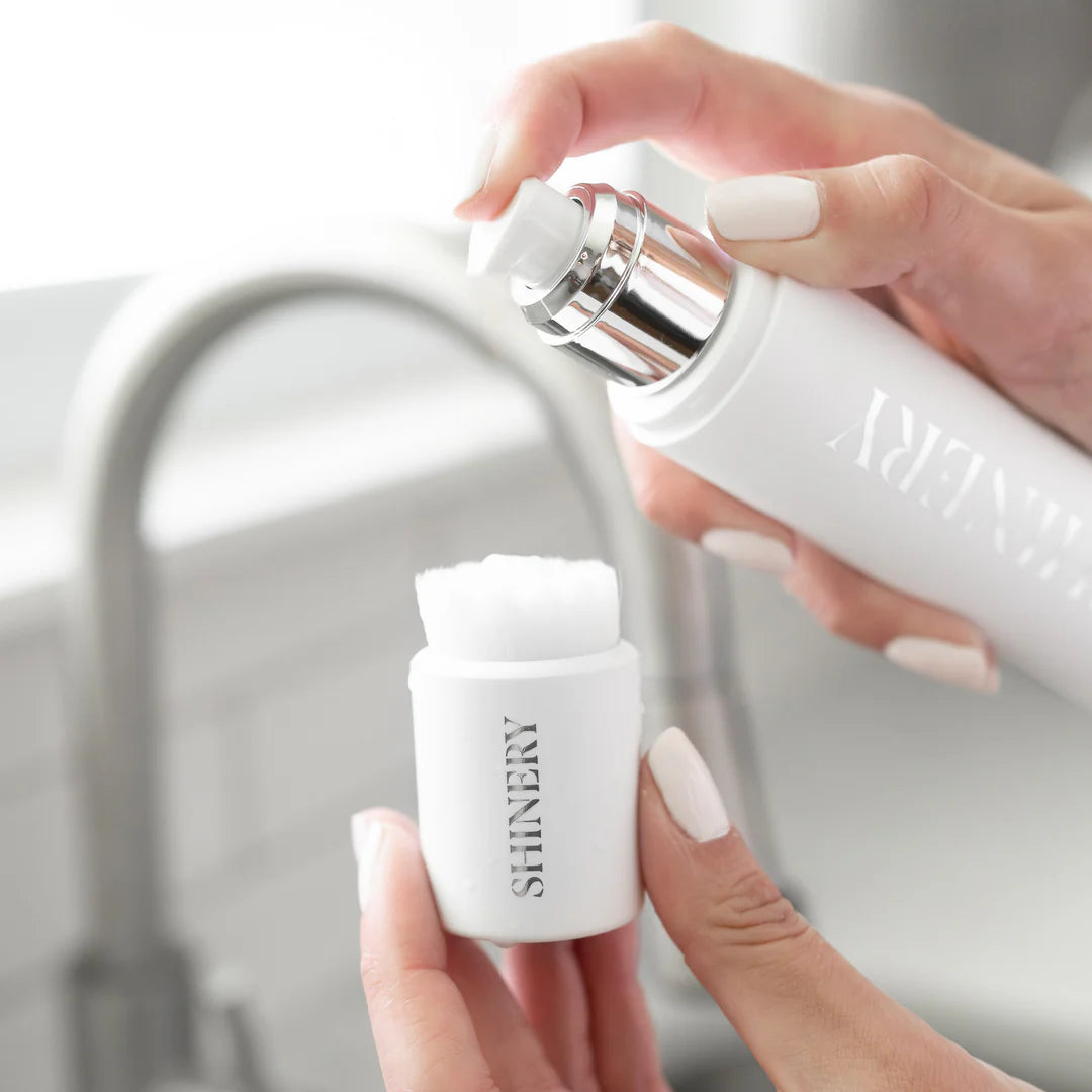 Hands squirting jewelry wash onto Radiance Brush