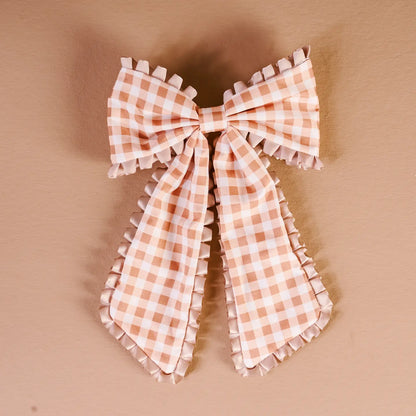 maple gingham Fancy Frills Hair Bow shown on a beige background