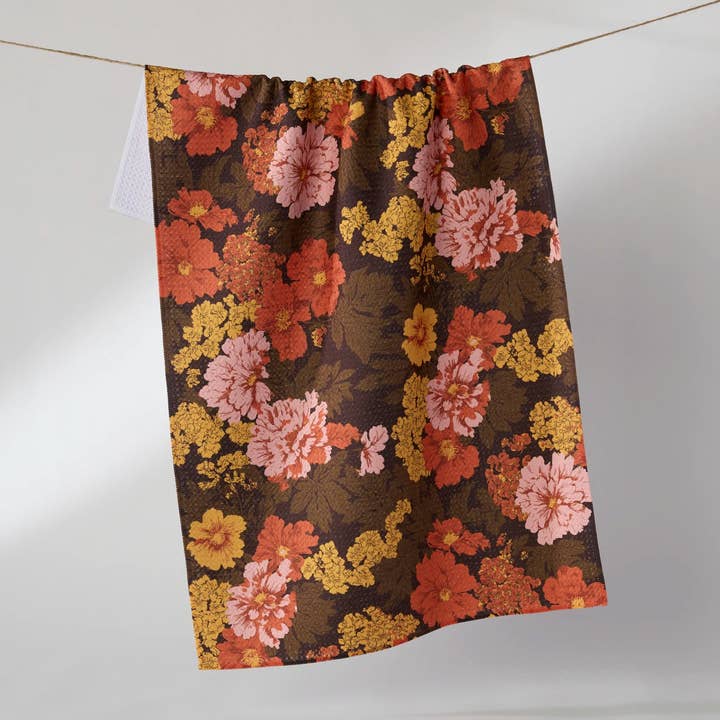 mabel tea towel partially hanging a clothesline on a grey background