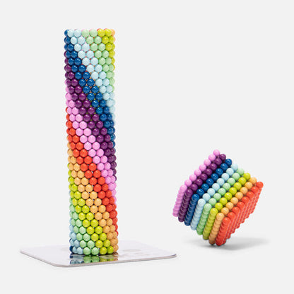 Matte Spectrum magnet balls displayed in the shape of a cylinder and a cube against a white background