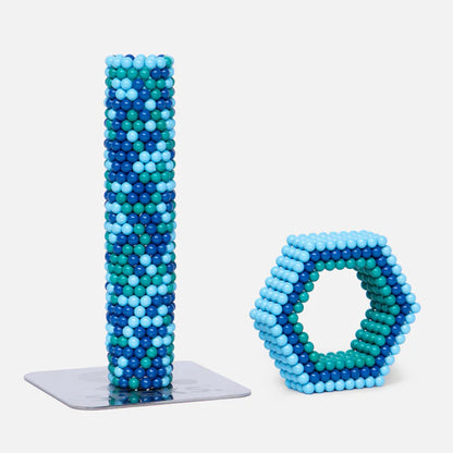 cylinder and other geometric shape made from magnetic balls in various shades of blues
