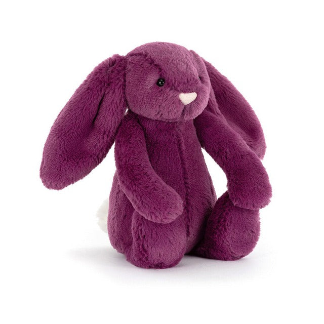 Plush purple bunny toy seated on a white background