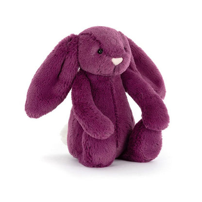 Plush purple bunny toy seated on a white background