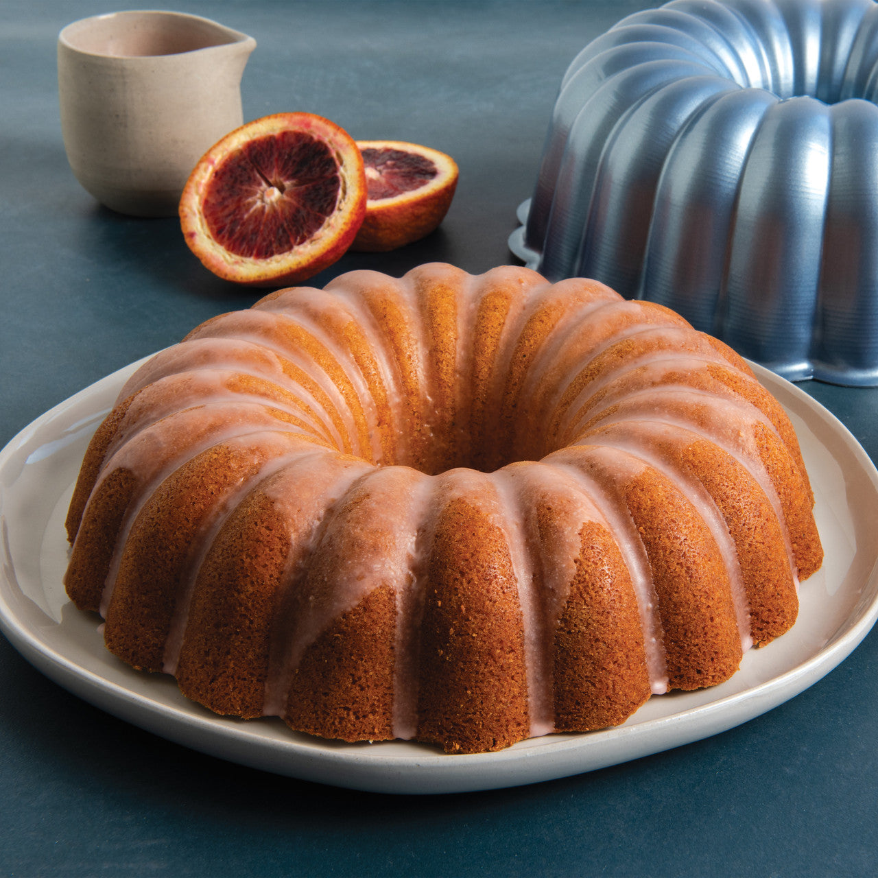 bundt cake on a platter with Party Bundt Pan in the background