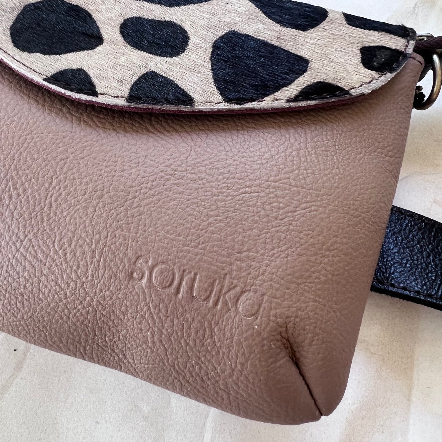 close-up of carol bag with stamped "soruka" logo.