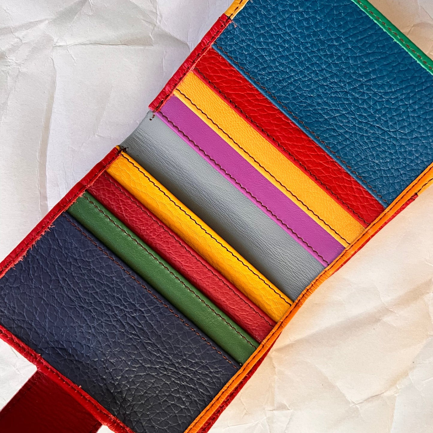 kelly wallet laying open showing multi-colored card slots.