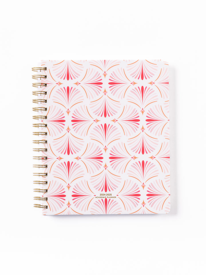 all tied up weekly planner with a pink geometric design.