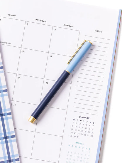blue so darling pen laying on a calendar.
