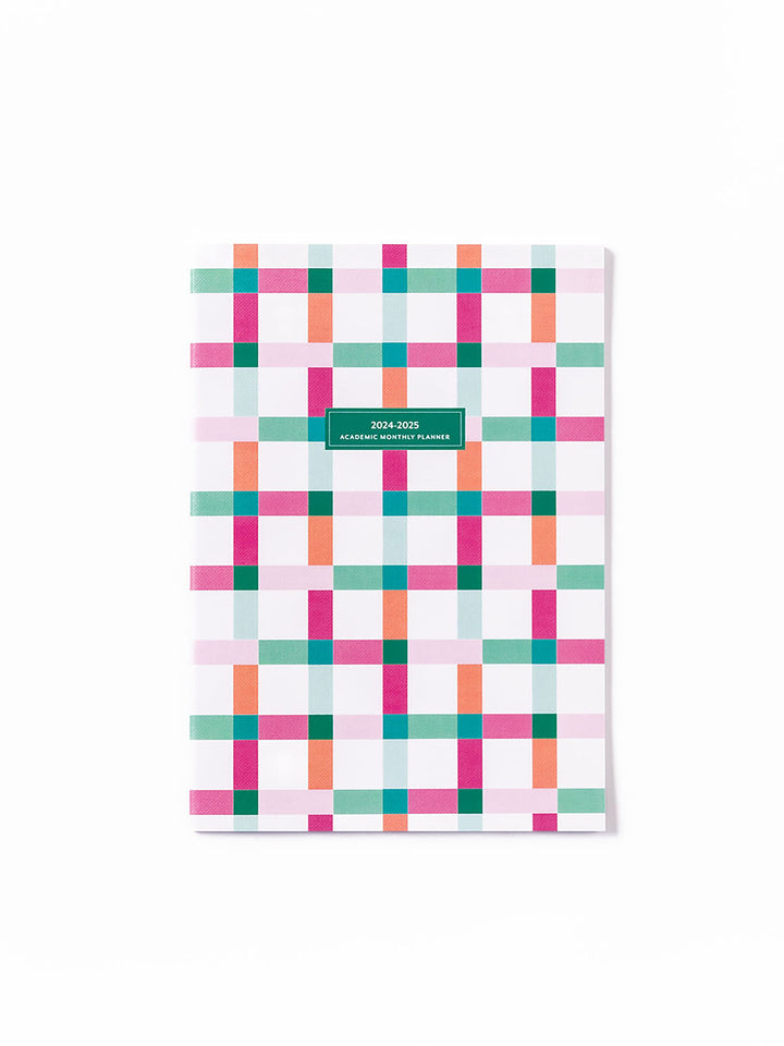 front cover of monthly planner with a pink, orange, and green check design.