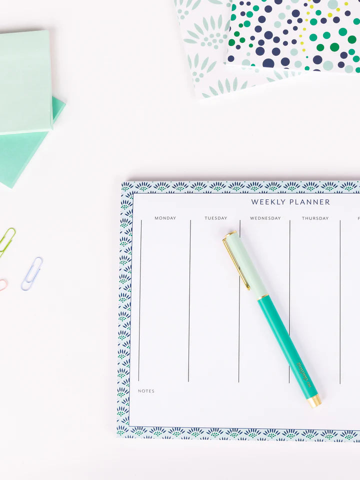 teal so darling pen laying on a calendar.