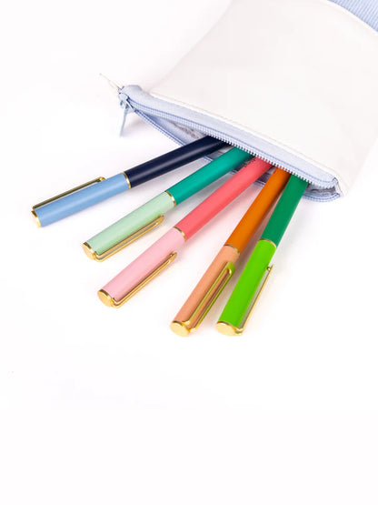 all 5 colors of so darling pens coming out of a zippered pouch.