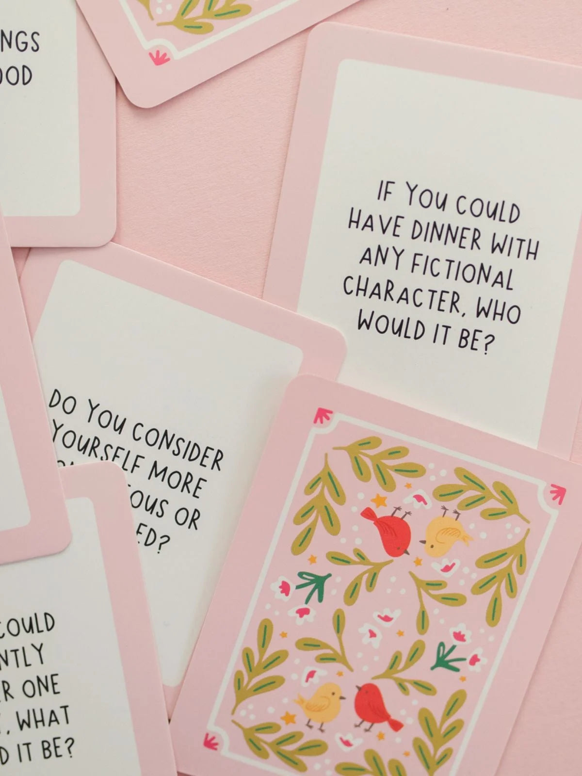 ask away cards scattered on a pink background