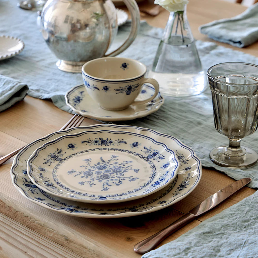 costa nova vila beige and blue dinner plate with coordinating salad plate set on it on a wooden table