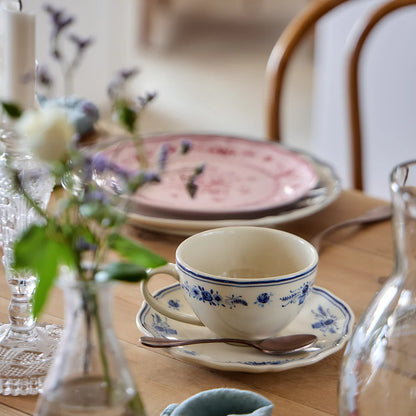 vila beige and blue tea cup with saucer on a wood table