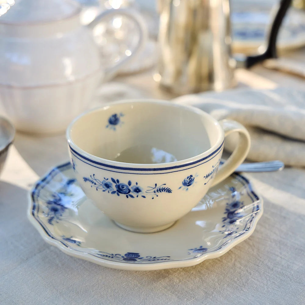 vila beige and blue tea cup with saucer on a decorated table