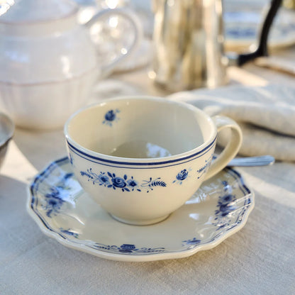 vila beige and blue tea cup with saucer on a decorated table