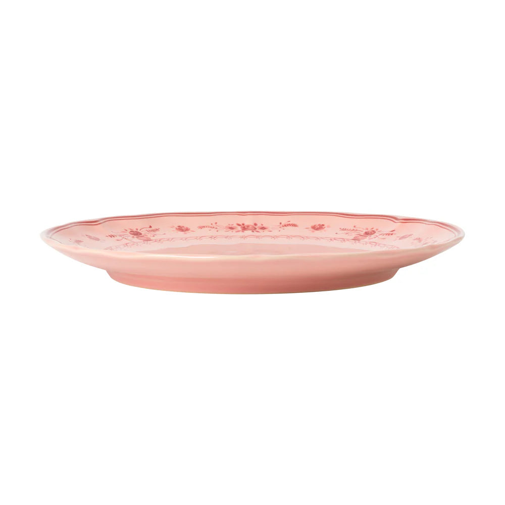 side view of costa nova vila pink dinner plate with red florals on the edge