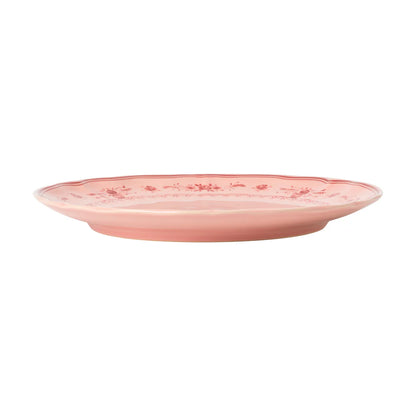 side view of costa nova vila pink dinner plate with red florals on the edge