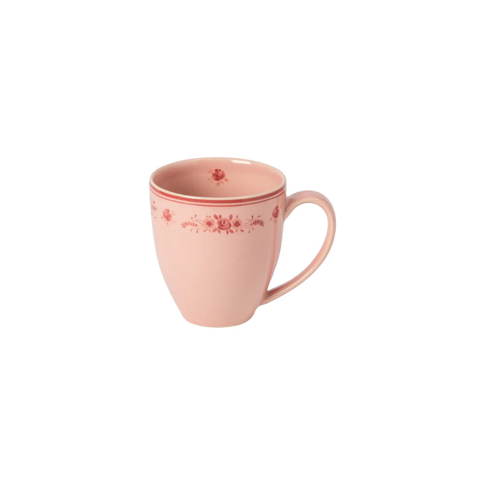 Pink mug with red floral pattern on a white background
