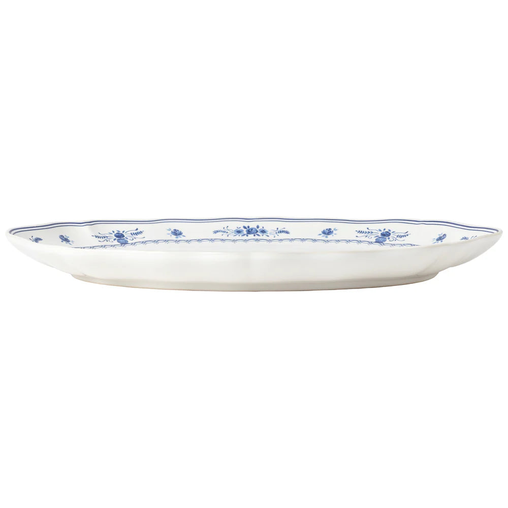 side view of White oval platter with blue floral patterns on a white background