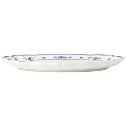 side view of White oval platter with blue floral patterns on a white background