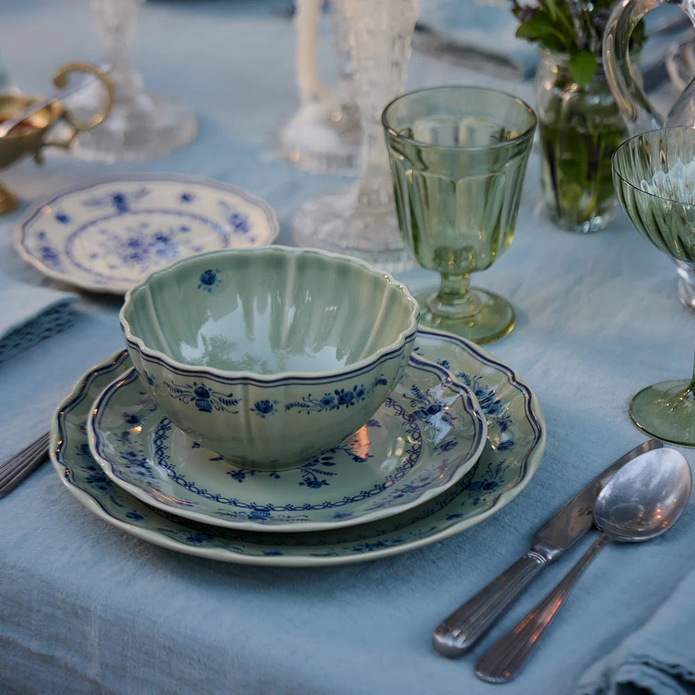 costa nova vila olive green and blue place setting pieces on a set table