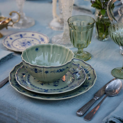 costa nova vila olive green and blue place setting pieces on a set table