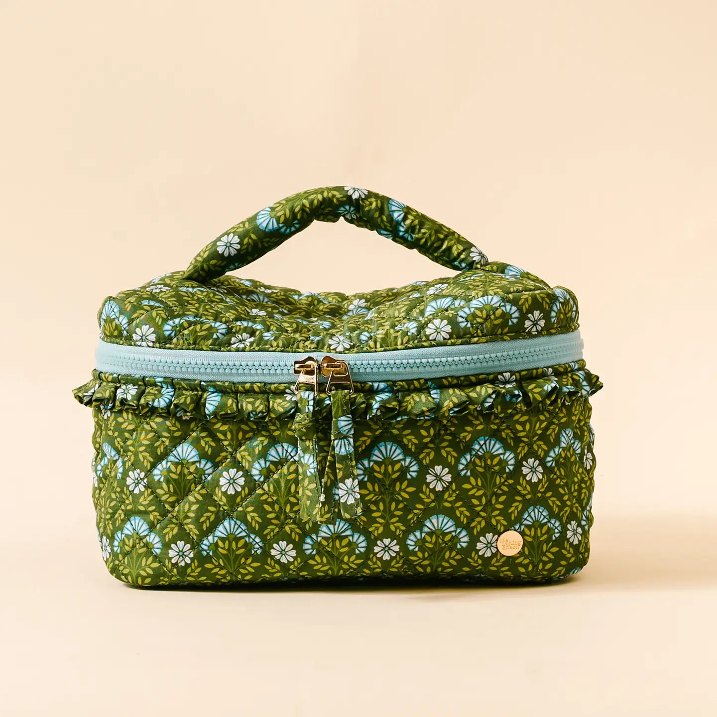 Everbloom Forest Green Glam & Go Quilted Cosmetic Bag shown on a beige background