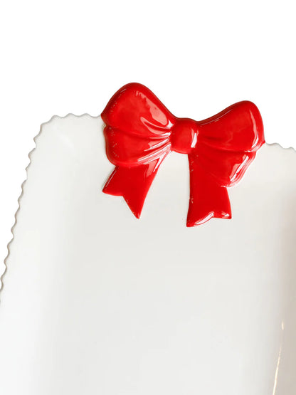 close-up of red ceramic bow on end of platter.