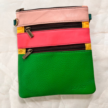 flat rectangular maya bag with top zipper and 2 zipper pockets color blocked in green and pinks.