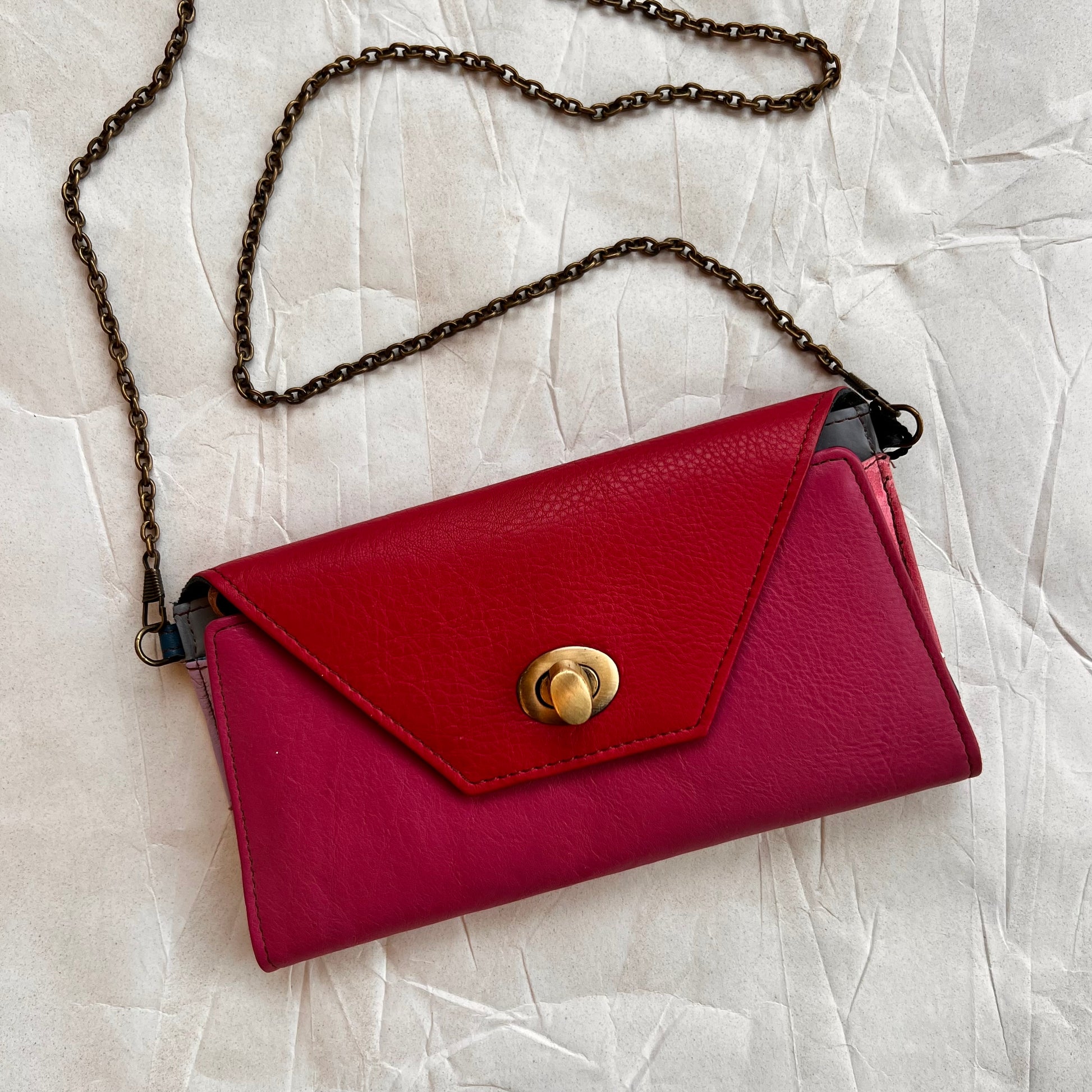berry secret clutch wallet with chain attached.