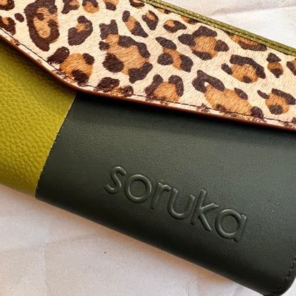 close-up of green judith wallet with animal print flap.