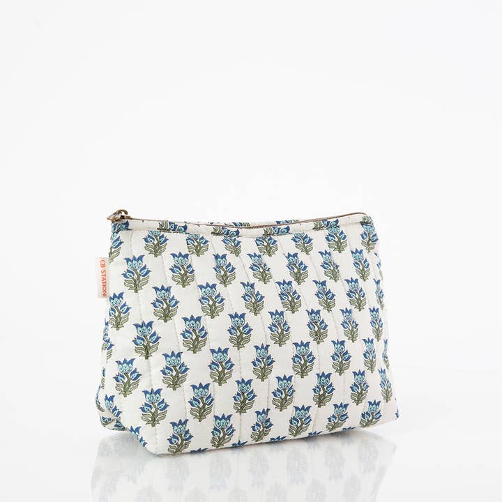 angled view of white zipper bag with aqua floral block print design
