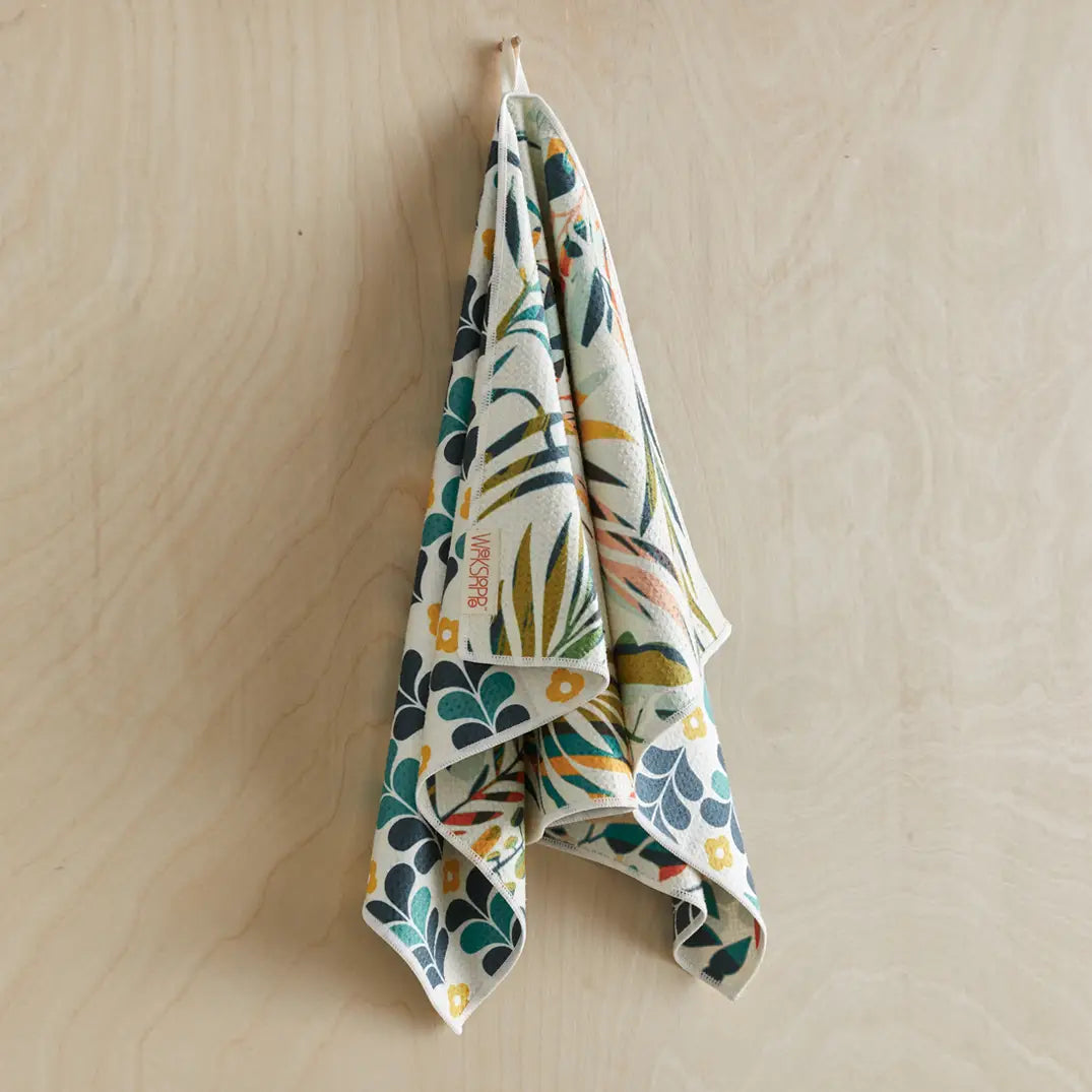 Colorful leaves dish towel hanging on a hook.