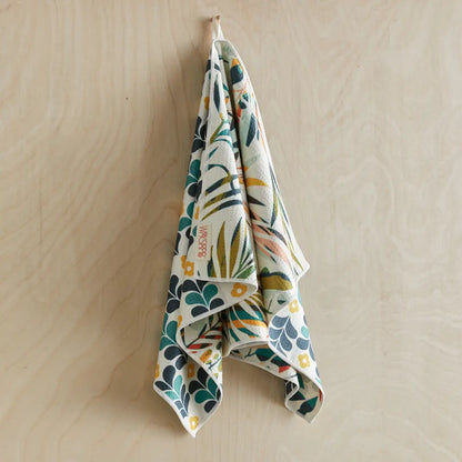 Colorful leaves dish towel hanging on a hook.