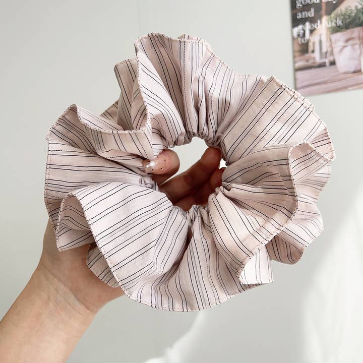 pink pinstripe scrunchie being held