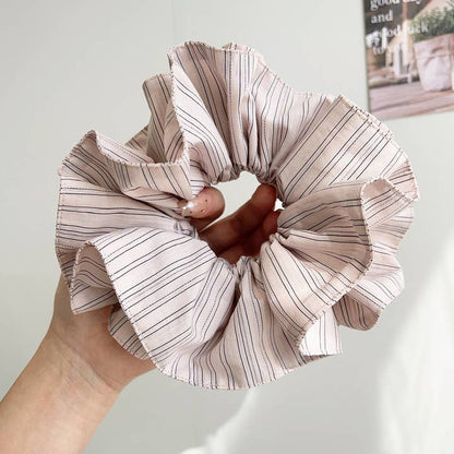 pink pinstripe scrunchie being held