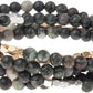 4.5 millimeter Kambaba Jasper beads interspersed with gold and silver beads wrapped four times to form a bracelet, shown on a white background.